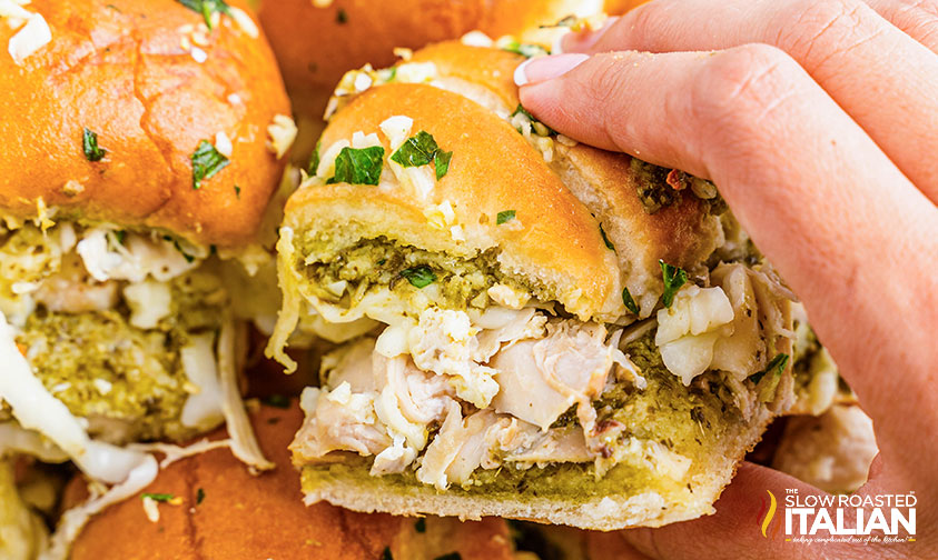 hand holding chicken pesto sliders