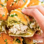 hand holding a chicken pesto slider