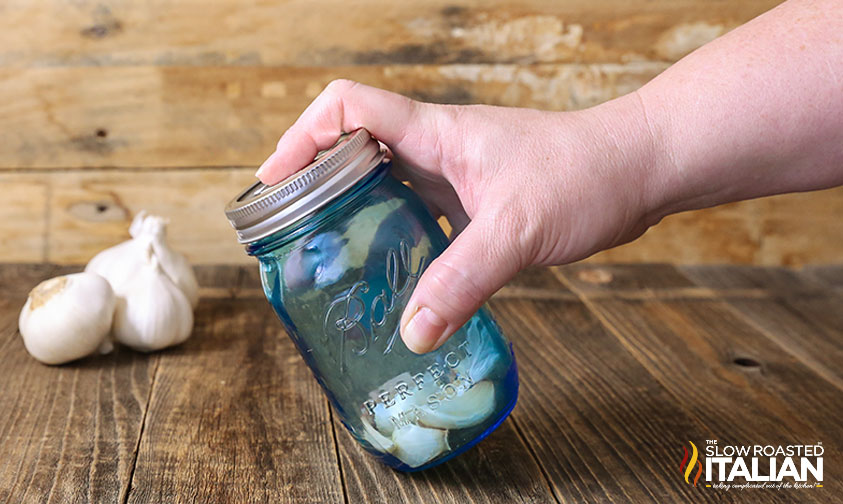 shaking garlic in a jar