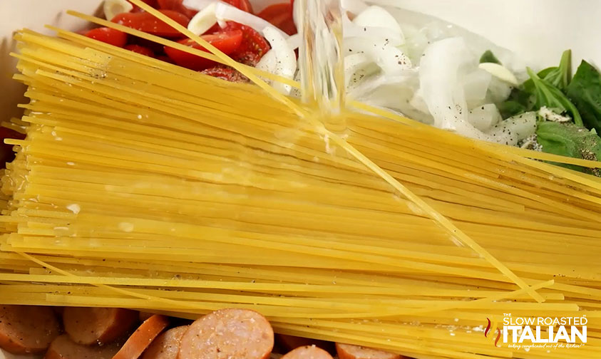 adding pasta and water to pot