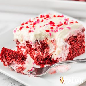 red velvet poke cake on a plate with a fork