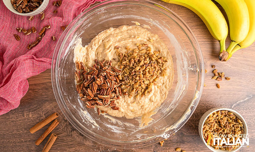 adding walnuts to banana bread batter