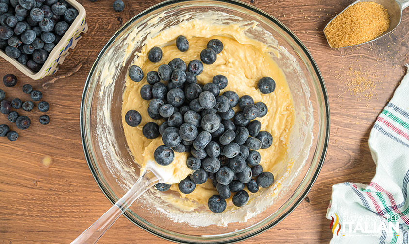 adding fresh blueberries to muffin batter