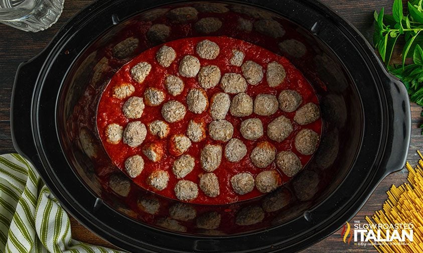 frozen meatballs and red sauce in crockpot