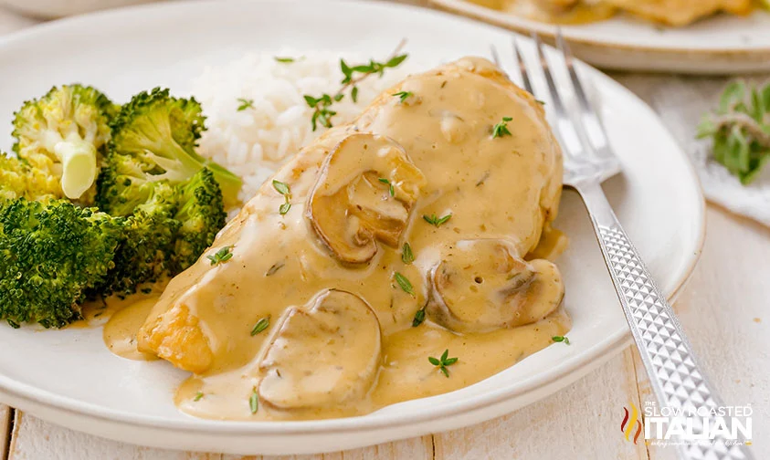 chicken with creamy mushroom sauce, rice, and broccoli on plate