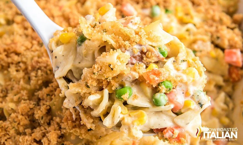 close up: spoonful of creamy noodle casserole with cracker topping