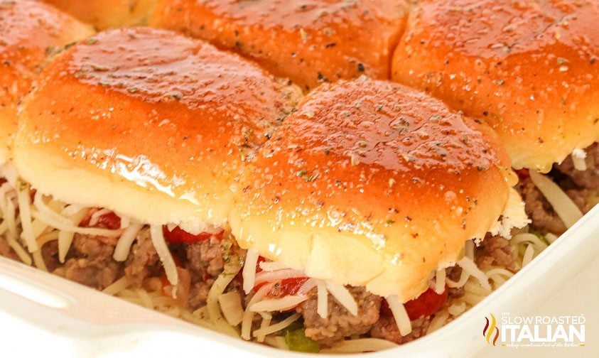 closeup: sausage sliders with cheese in casserole dish
