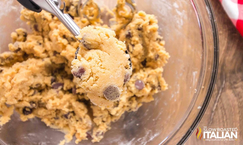 using a cookie scoop to scoop dough for chocolate chip cookies