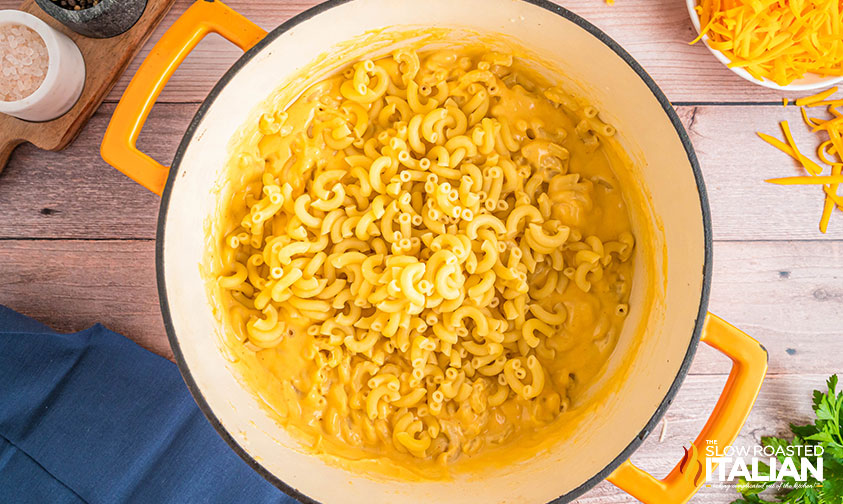 adding cooked macaroni to pot