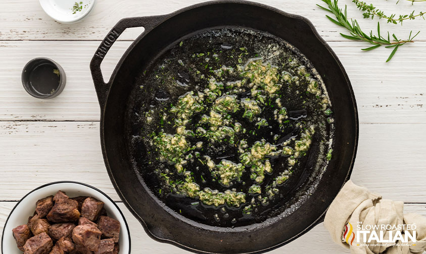 garlic butter and herbs added to skillet