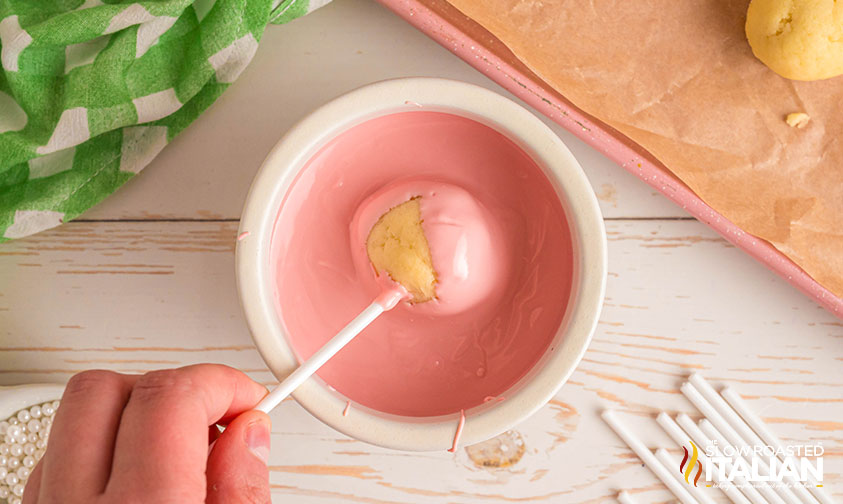 dipping cake pop into candy melts