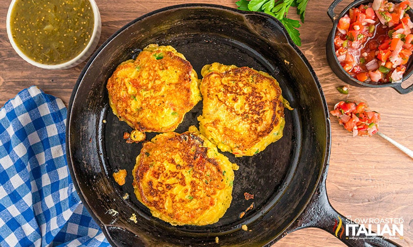 fried sweet corn tamale cakes in a cast iron skillet