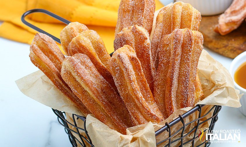 churros standing upright in parchment lined basket