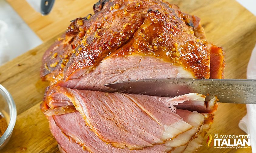 overhead: knife slicing into brown sugar maple ham
