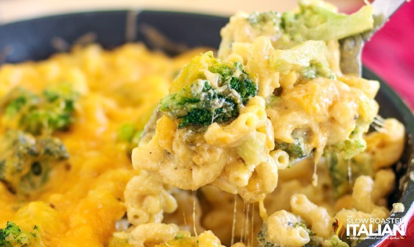 close up: scooping broccoli mac and cheese out of dutch oven
