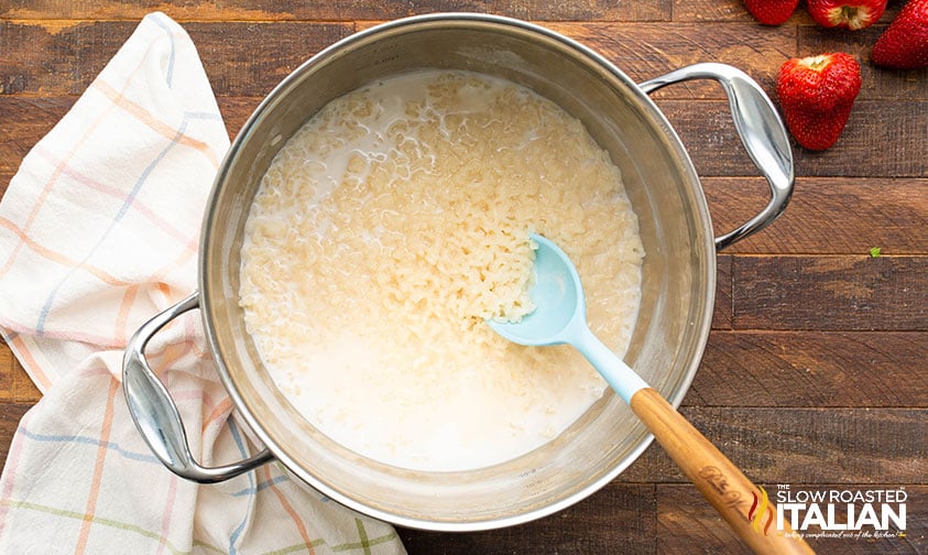 stirring rice and creamer in a large pot