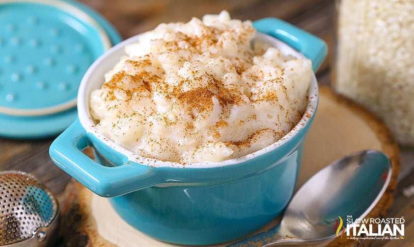 bowl of creamy rice pudding recipe with cream in a blue bowl
