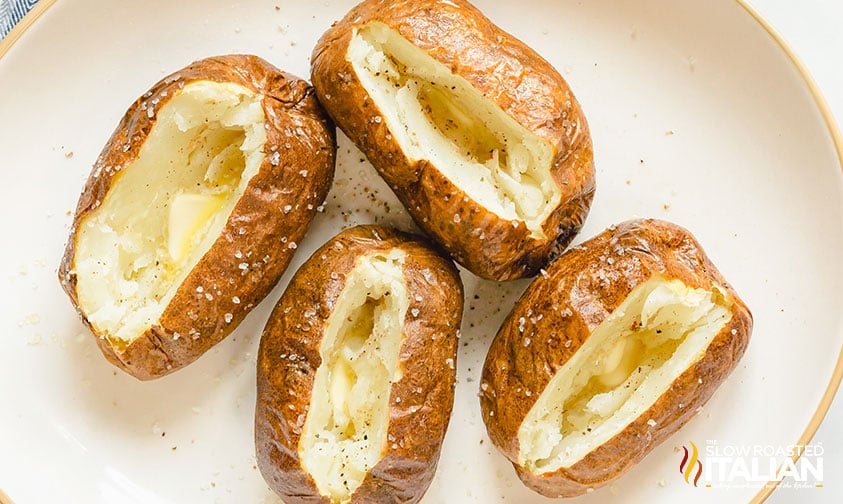 split open air fryer potatoes on a white plate