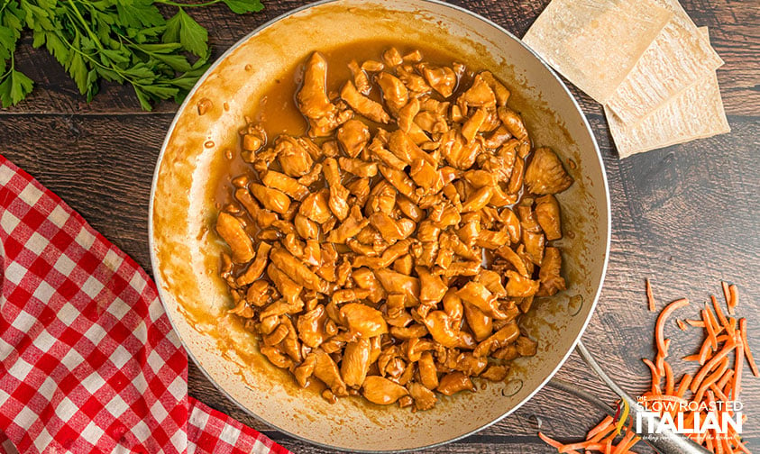 cooked marinated chicken in a large skillet