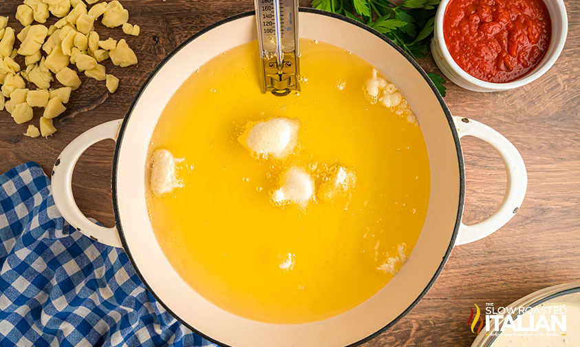 frying cheese curds in a large pot