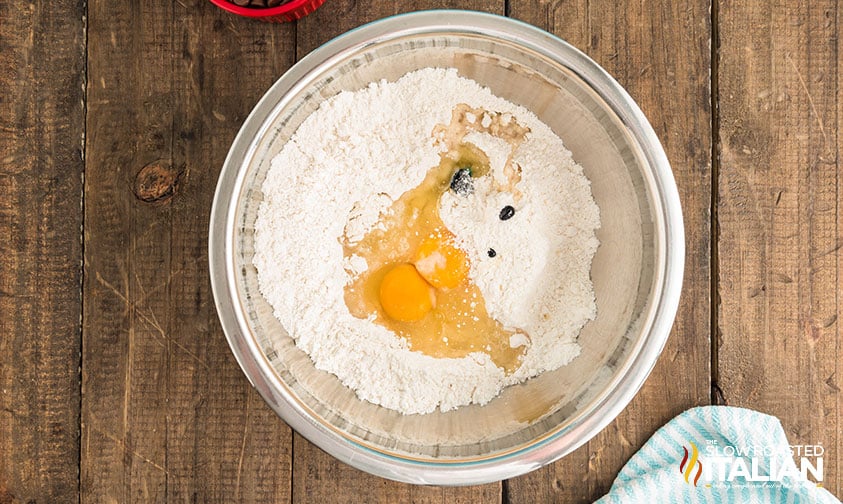 cake mix, eggs and blue food color in a mixing bowl