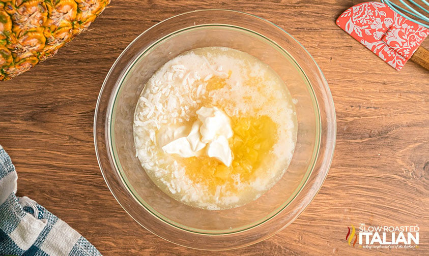sour cream, cream of coconut, pineapple and shredded coconut in a mixing bowl