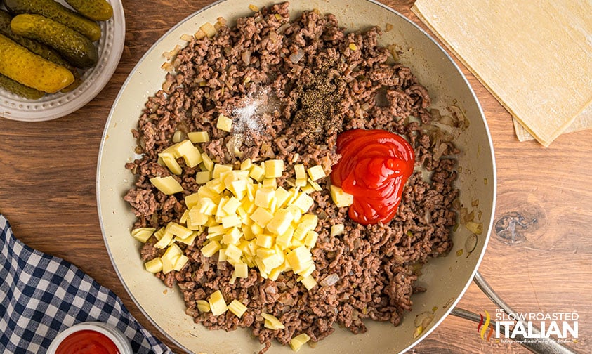 browned beef, onions, diced american cheese and ketchup in a skillet