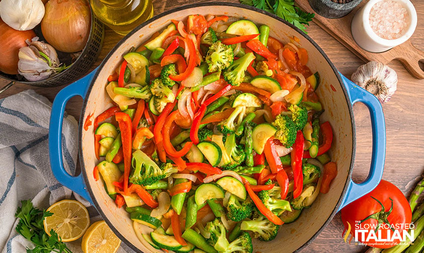 onions, broccoli asparagus, red pepper zucchini and tomatoes in a dutch oven