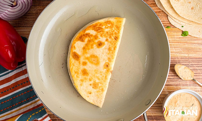 browning a cheese quesadilla in a skillet