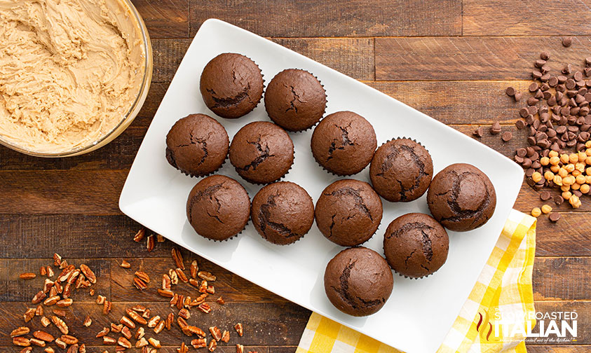 baked turtle cupcakes on a serving tray