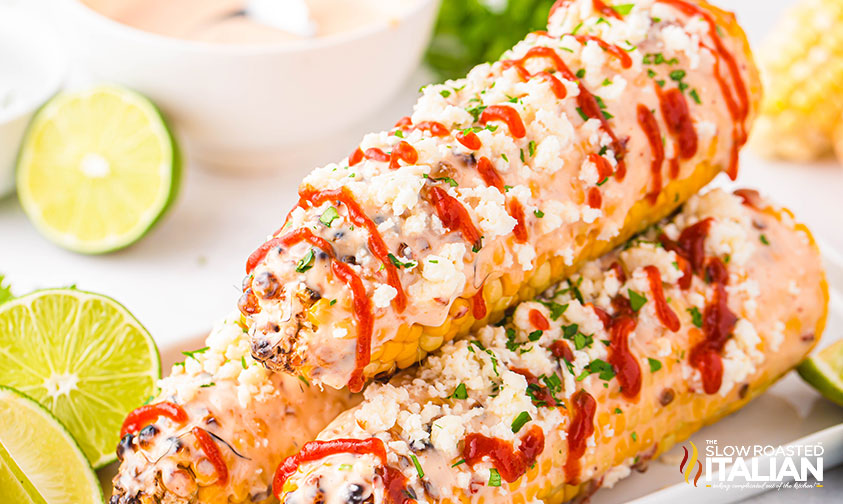 closeup of stacked elote mexican street corn on a serving tray