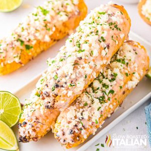 3 ears of elote mexican corn on a serving tray