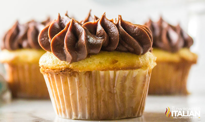 fluffy chocolate buttercream piped on a cupcake