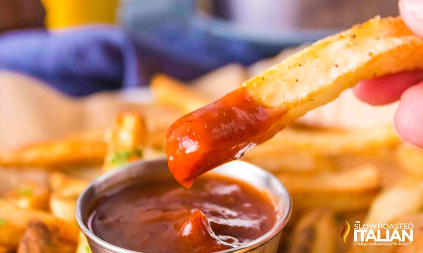 closeup of homemade french fry dipped in ketchup