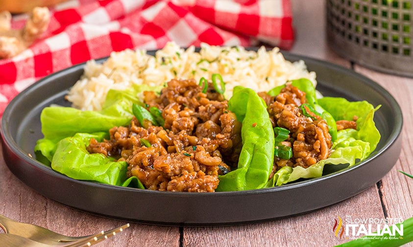 3 pf chang's chicken lettuce wraps on a plate with a side of rice