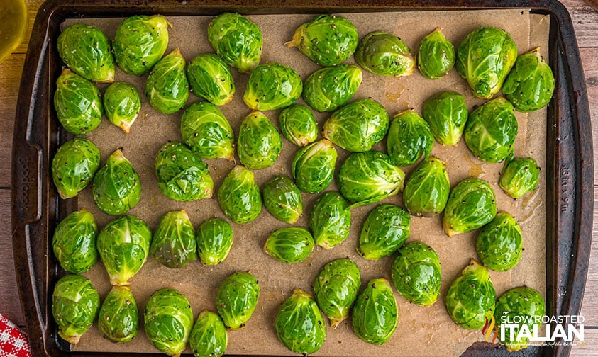 olive oil coated brussel sprouts on a sheet pan