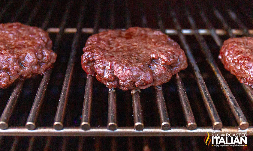 smoked burgers on a grill rack