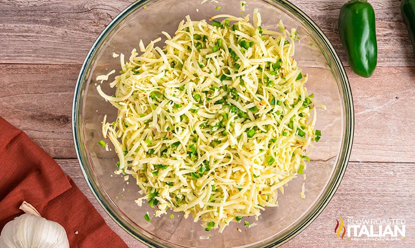 shredded pepper jack cheese and diced jalapenos in a mixing bowl