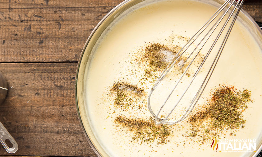 adding seasoning to saucepan