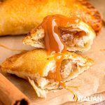 caramel apple empanada sliced on parchment paper