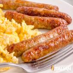 air fryer sausage links on a plate with scrambled eggs