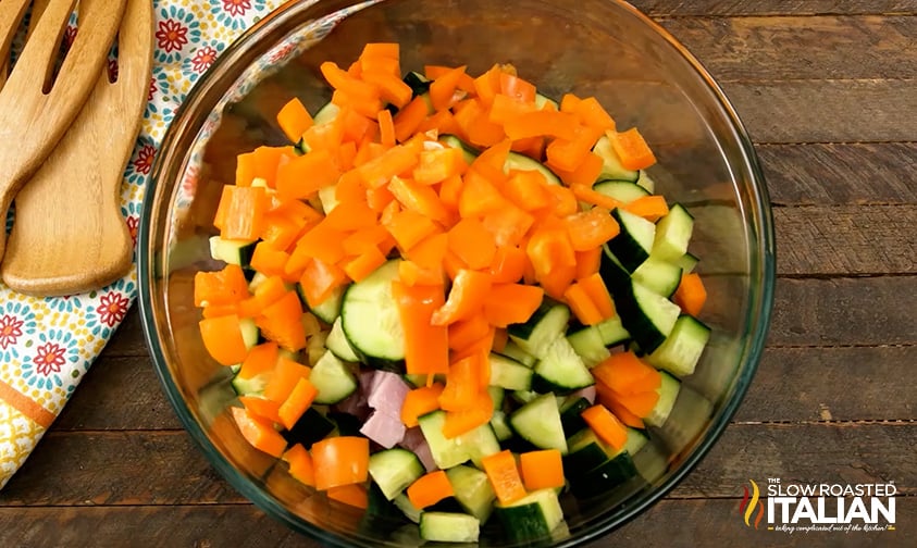 cucumber, orange bell pepper, and cubed ham in a bowl