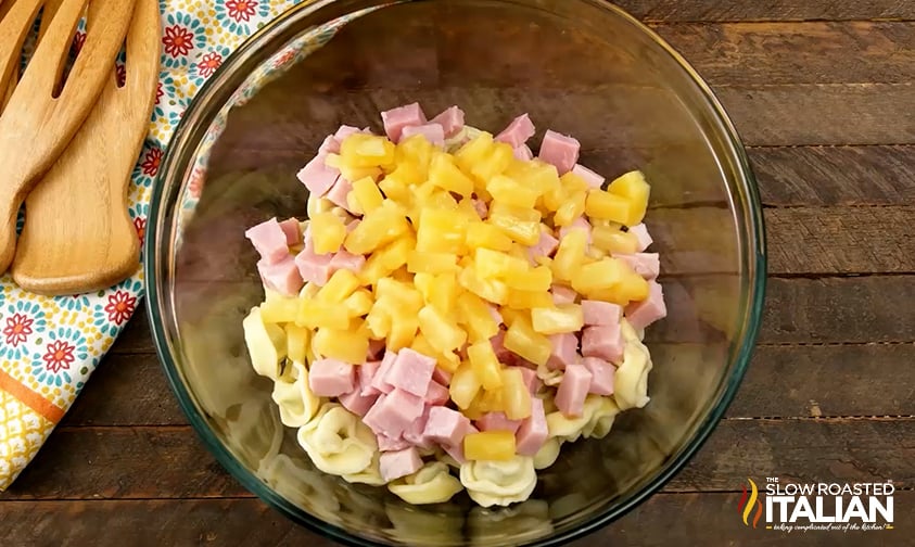 pineapple tidbits over cubed ham and tortellini in bowl