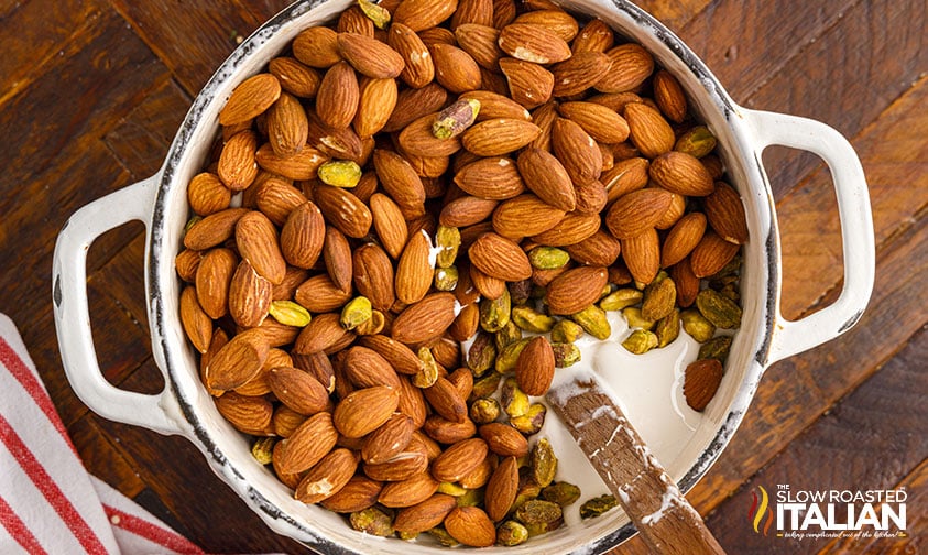 almonds and pistachios added to pot of nougat mixture