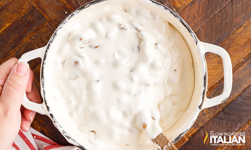 stirring nuts into nougat candy base