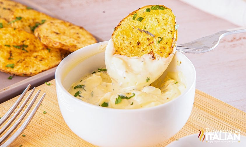 roasted cottage fry dipped in a bowl of creamy dip