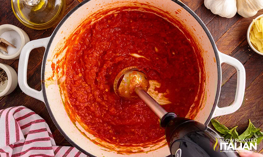 blending tomato pasta sauce in pot with immersion blender