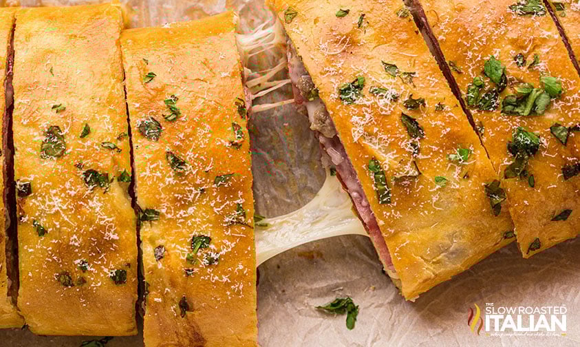 cheese pull connecting slices of Italian stromboli