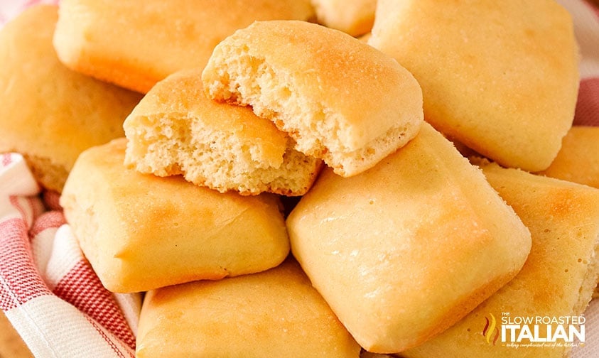 close up: Texas Roadhouse roll torn in two on top of pile