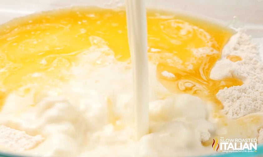 pouring milk into bowl with melted butter and dry ingredients for Red Lobster biscuits